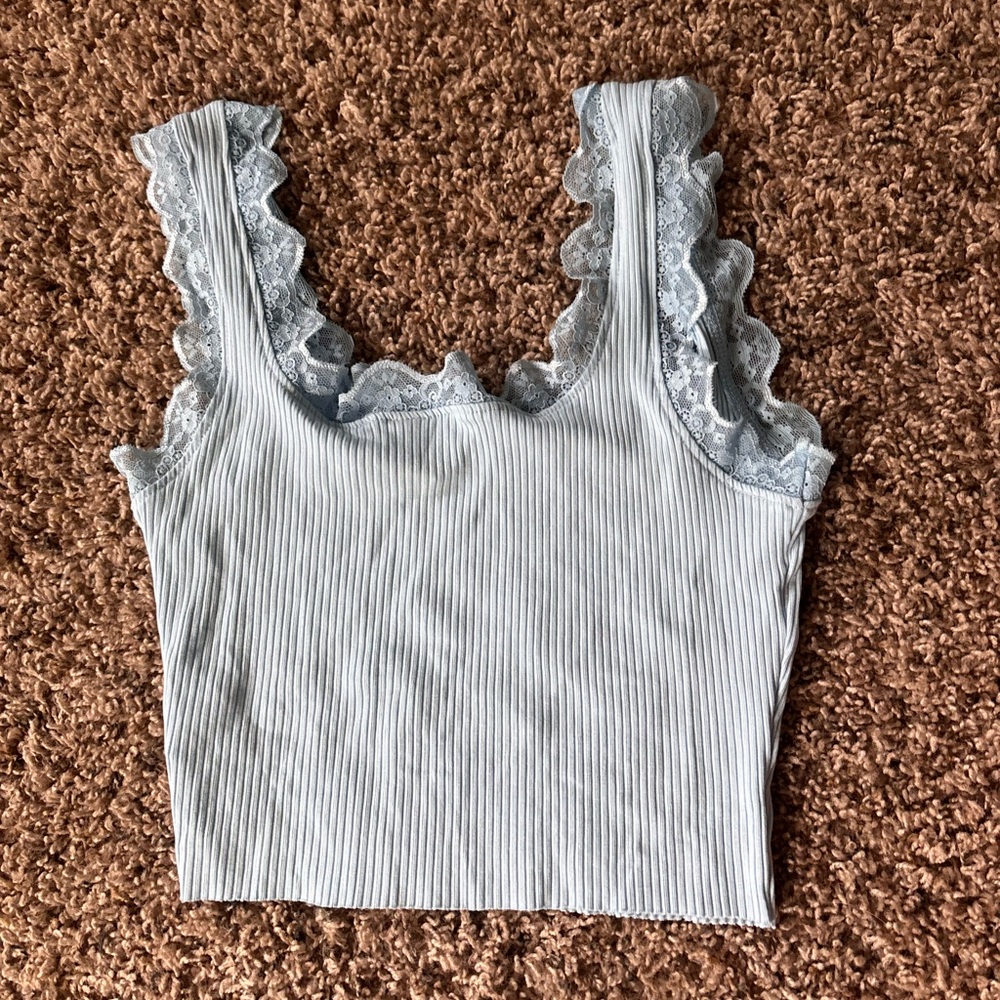 Cute baby blue crop top with lace bordered straps. Never worn before!